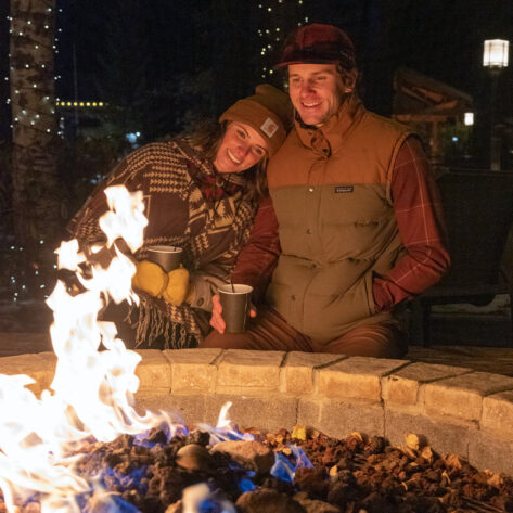 A couple sits by the fire at Seventh Mountain Resort near Bend, Oregon.
