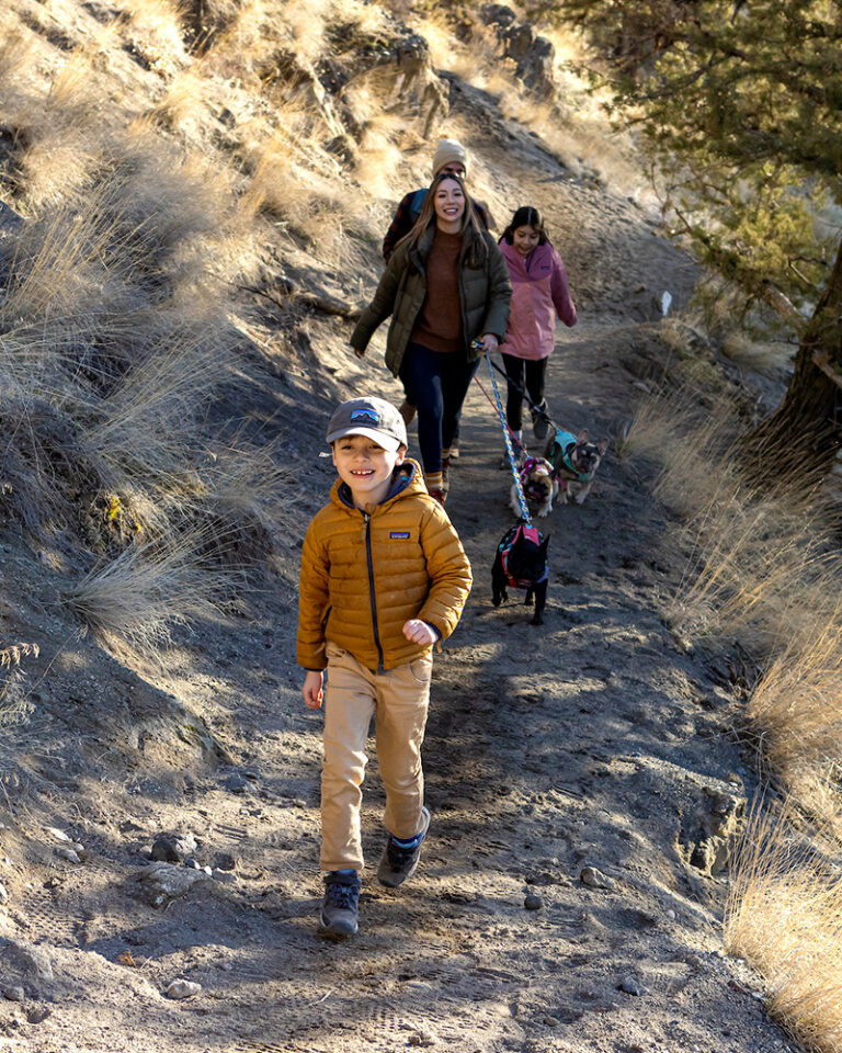 A family hikes the trail to Steelhead Falls near Bend, Oregon.
