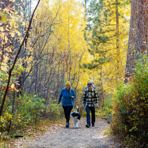A family walks through Shevlin Park in the Fall on the Westside of Bend, Oregon.