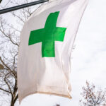 Green cannabis cross flag in Bend, OR