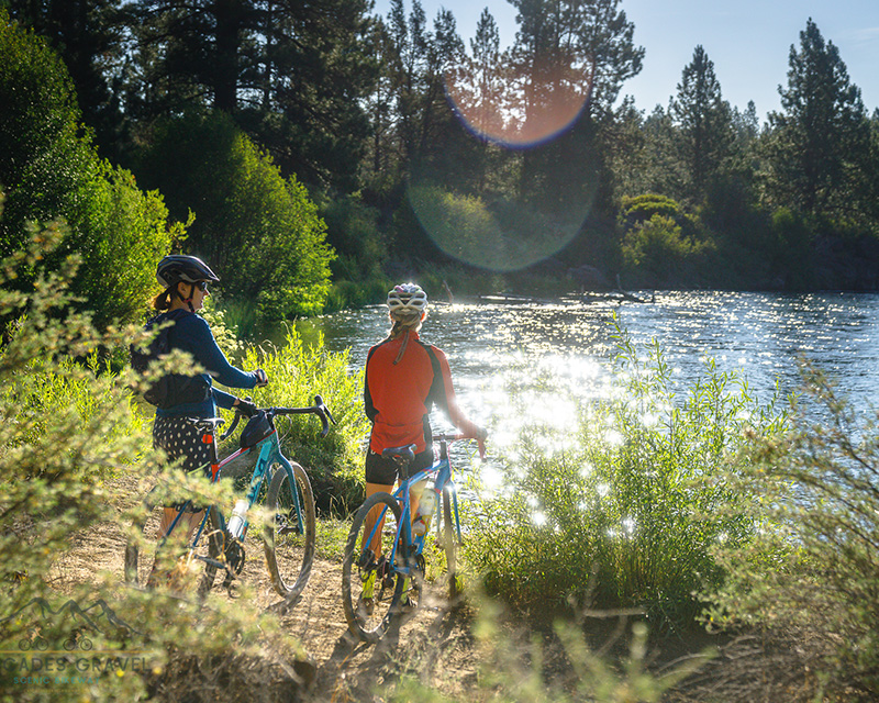 Gravel cyclists looking at the river at La Pine State Park, near Bend, OR