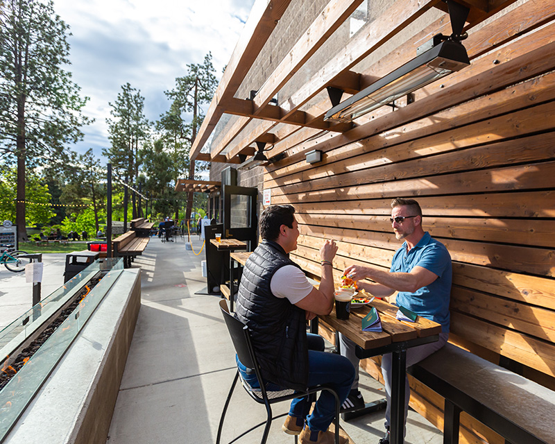 Outdoor seating and river view at Bend Brewing Co in Bend, OR
