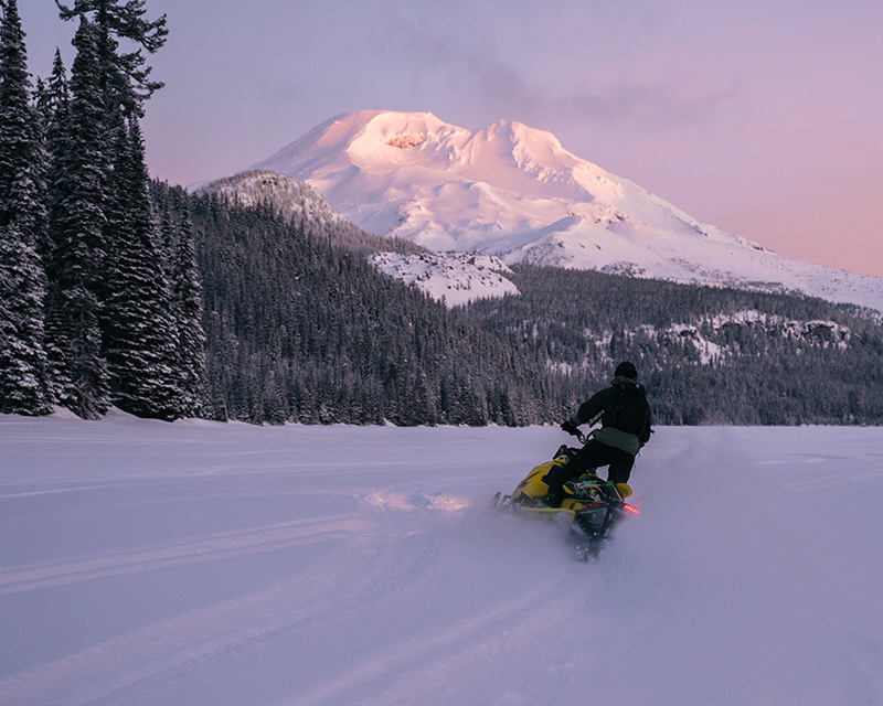 Snowmobiling with a cascade mountain view near Bend, OR