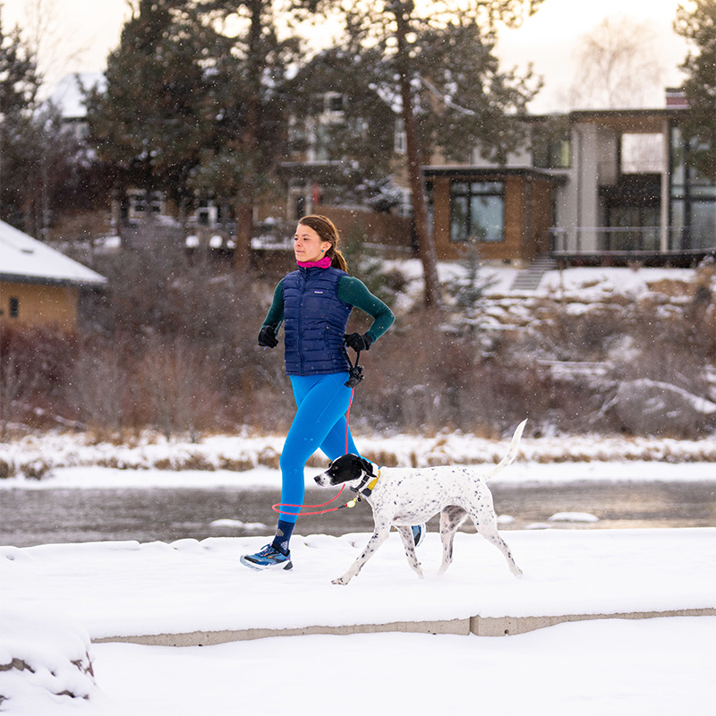 A runner and her dog along the Deschutes River Trail in Bend, Oregon. 