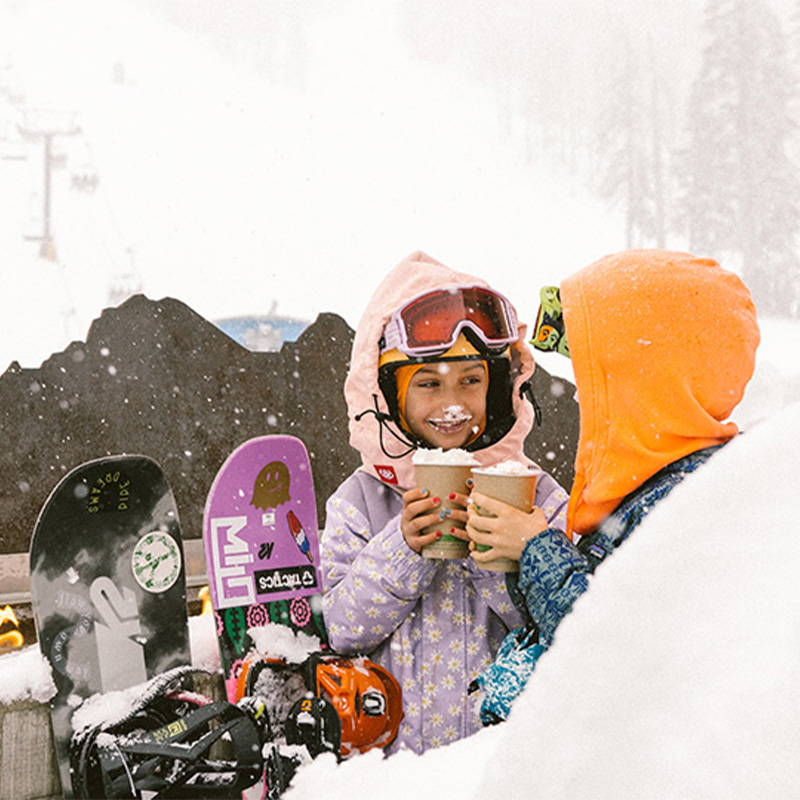 Two kids enjoy hot cocoa near the slopes at Mt. Bachelor. 