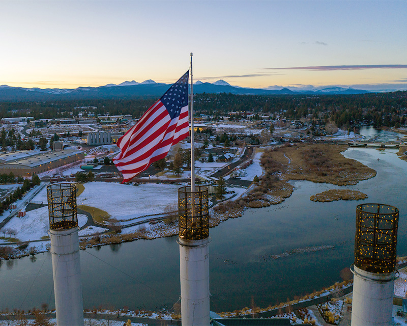The American Flag atop the smokestacks in the Old Mill Shopping District in Bend, Oregon.