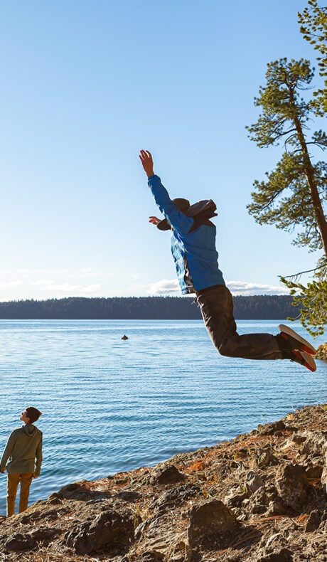 Jumping on the shore of Paulina Lake in Newberry National Volcanic Monument near Bend, OR