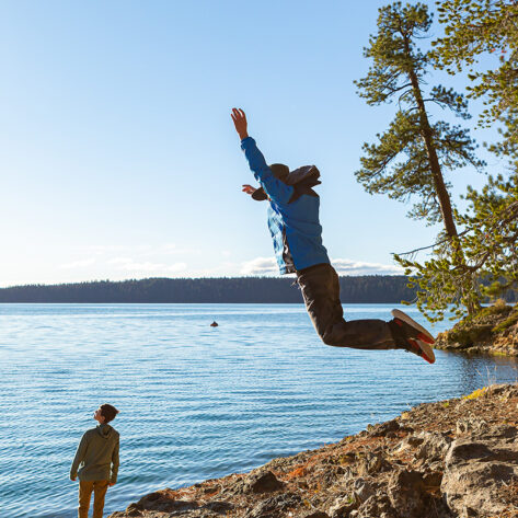 Jumping on the shore of Paulina Lake in Newberry National Volcanic Monument near Bend, OR