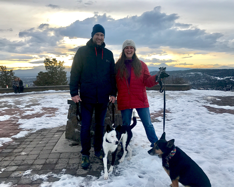 Blogger Tawna stands atop Pilot Butte (a real volcano!) with husband, Craig, and their pups.