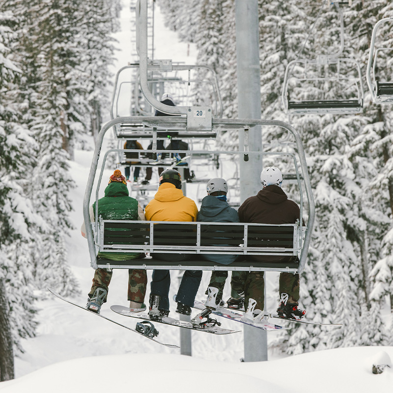 A group of friends ride the chairlift at Mt. Bachelor in Bend, Oregon. 