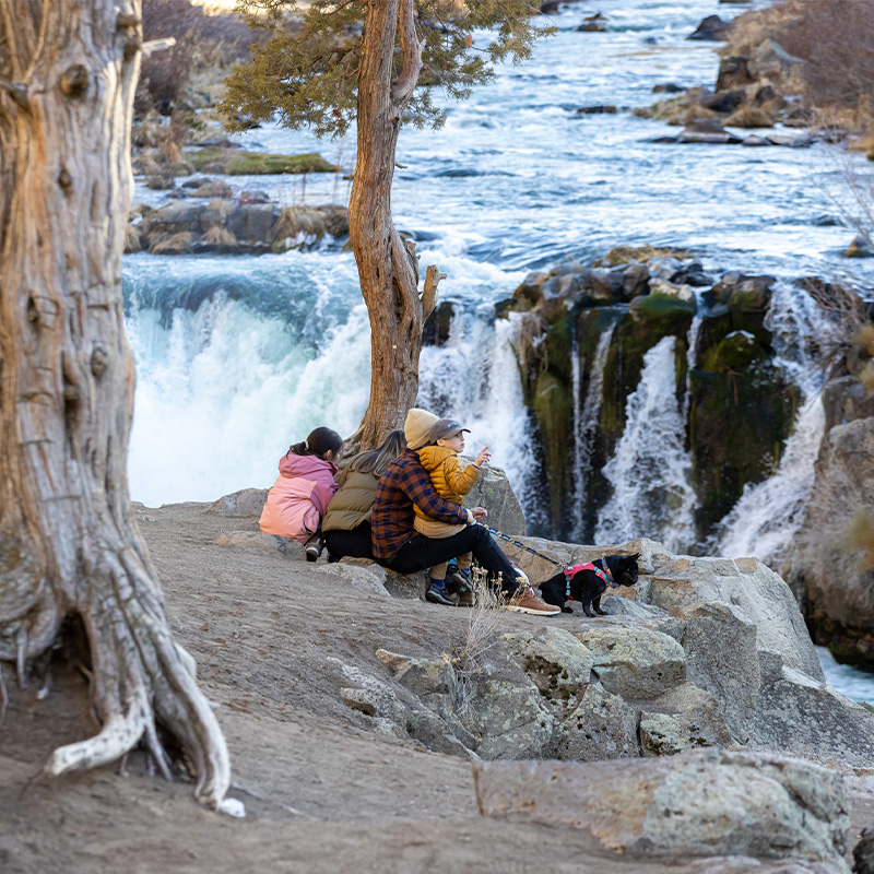 A family hikes to Steelhead Falls in Bend, Oregon. 