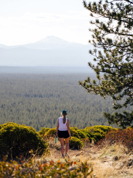 A woman hikes along the trail on a butte in Bend, Oregon.