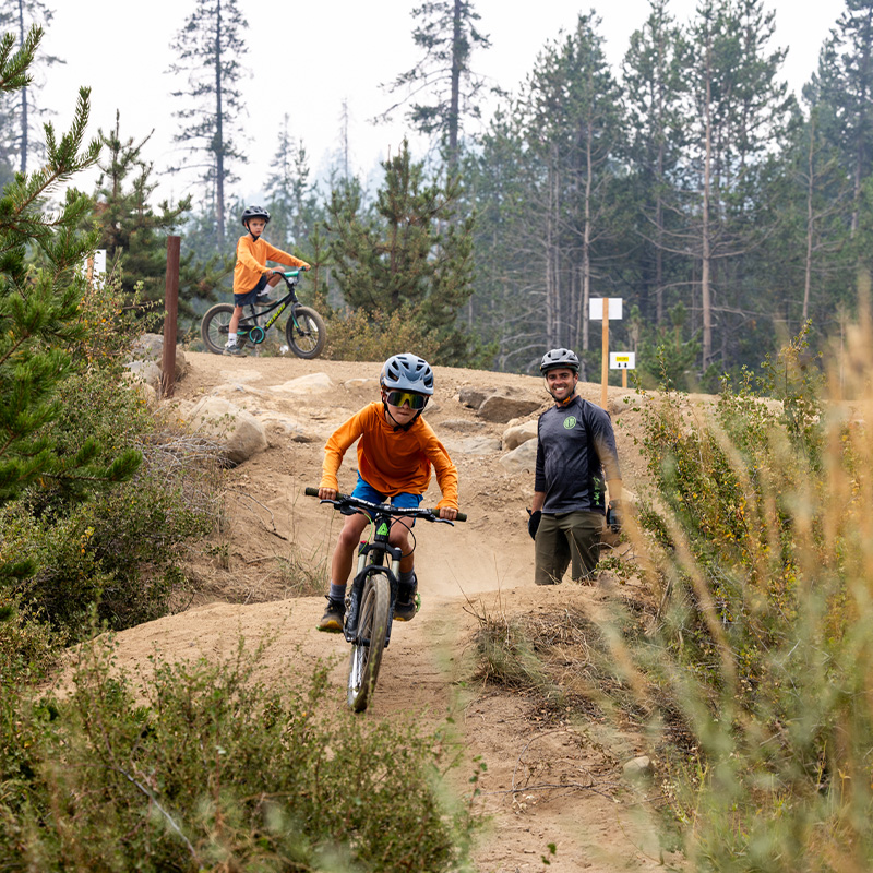 A family rides mountain bikes at the Wanoga Pump Track in Bend, Oregon. 