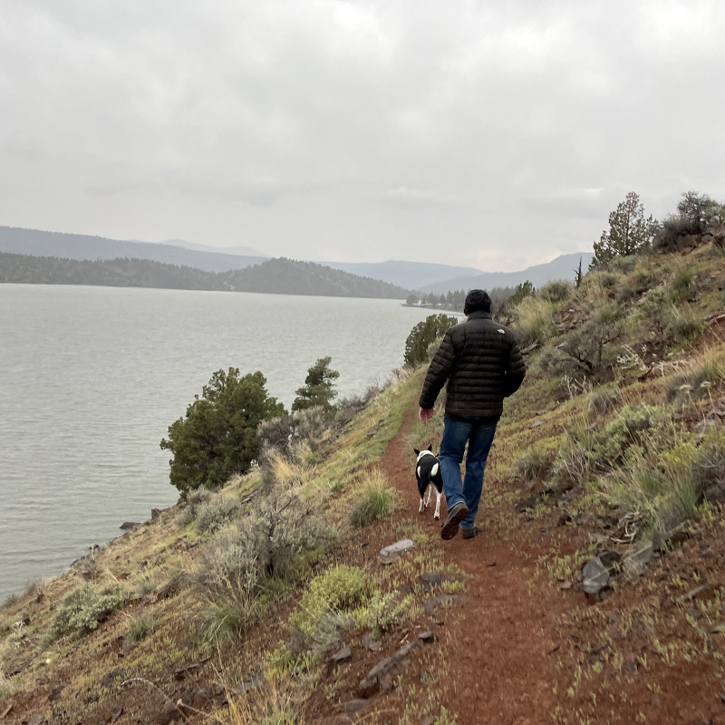 Blogger Tawna's husband and dog Jack hike along the bank of Prineville Reservoir. 