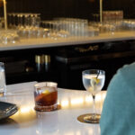 Zero-proof cocktails at Dear Irene in downtown Bend, Oregon, featuring a Path Less Taken mocktail on the bar beside a classic martini glass.”