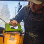 A man waxing a ski at a shop in Bend, OR